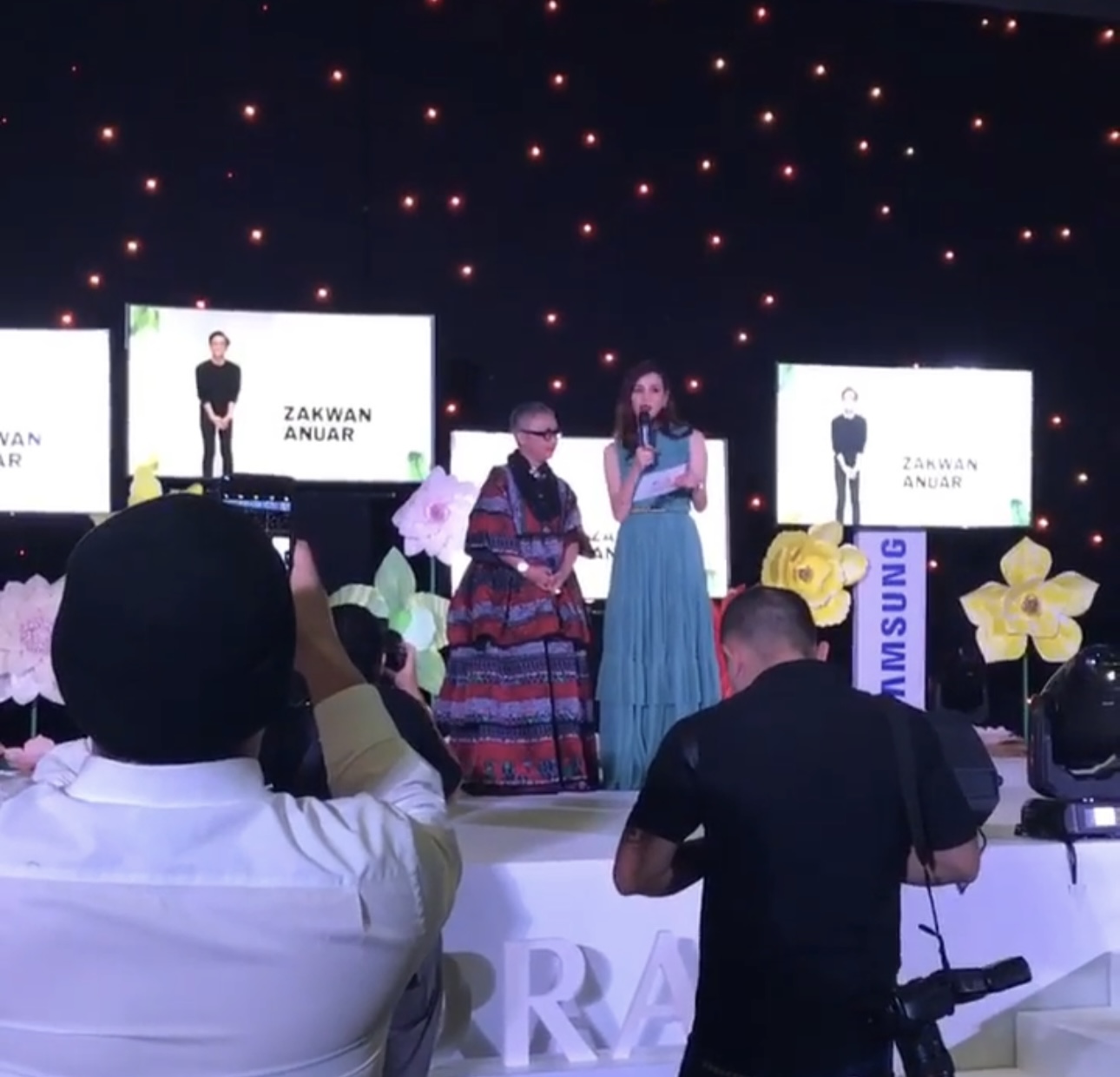 Chanela speaking on stage